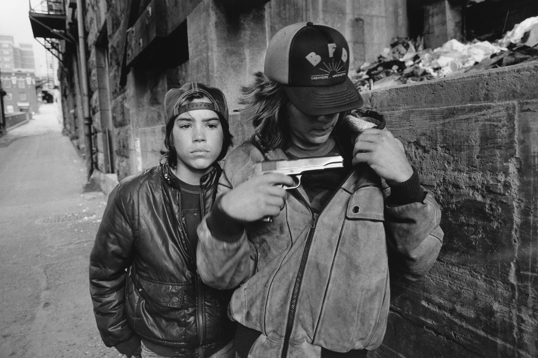 "Rat" and Mike with a Gun, Seattle, Washington, 1983  Gelatin silver print; printed later  11 x 14 inches