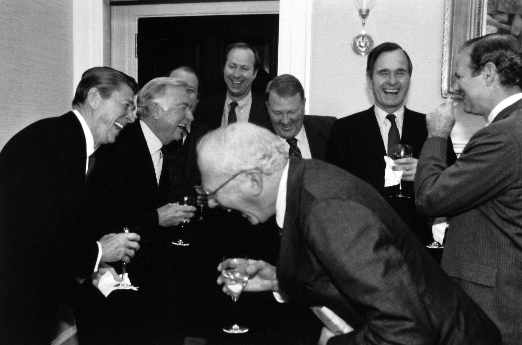 Diana Walker - President Reagan, Walter Cronkite, Jim Brady, David Gergen, Ed Meese, Vice President Bush, Jim Baker and CBS's Bud Benjamin, sharing a joke at the White House, March 3, 1981 - Howard Greenberg Gallery - 2018