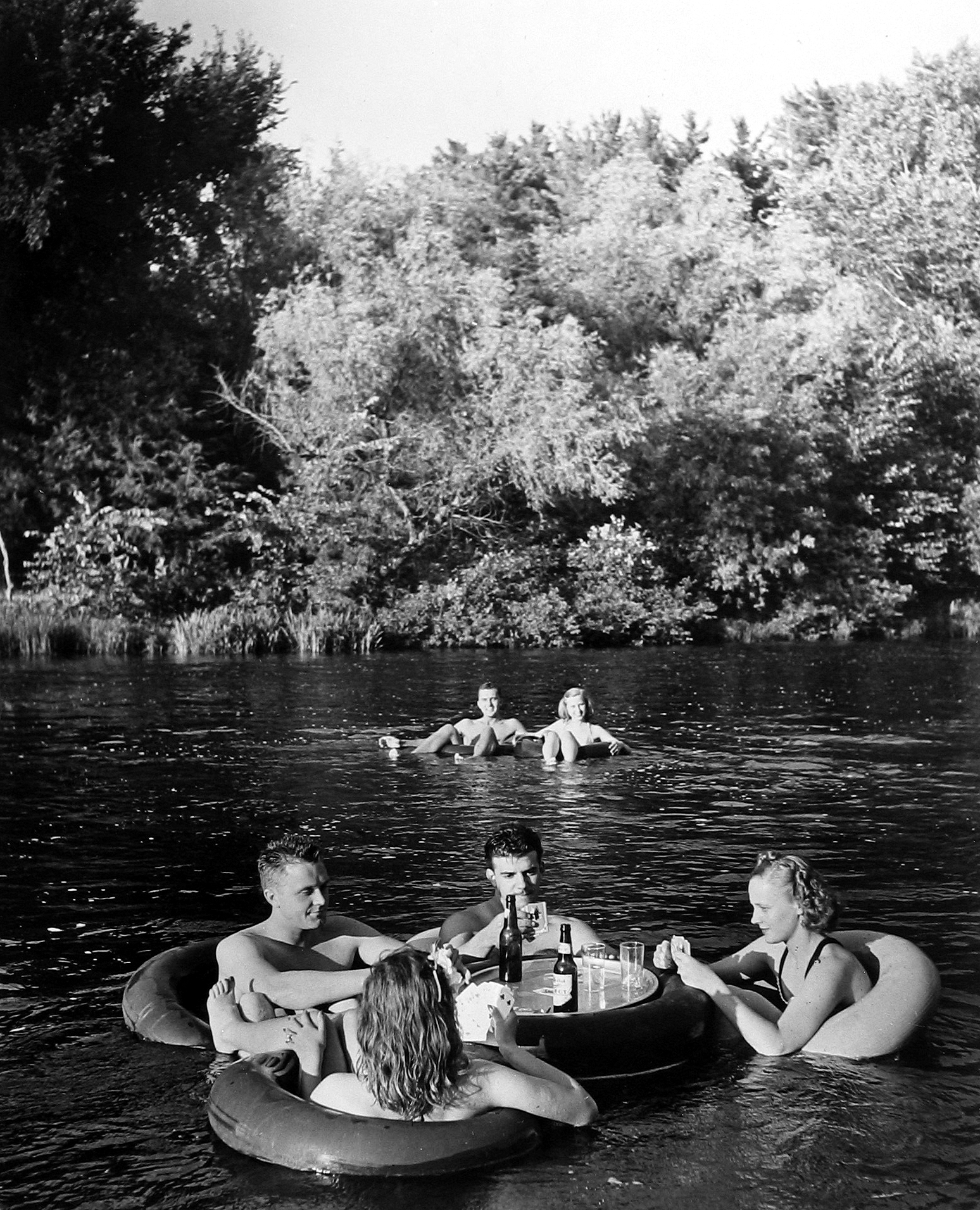 Alfred Eisenstaedt - Bridge playing couples at innertube party, Apple River, Somerset, WI, 1941 - Howard Greenberg Gallery