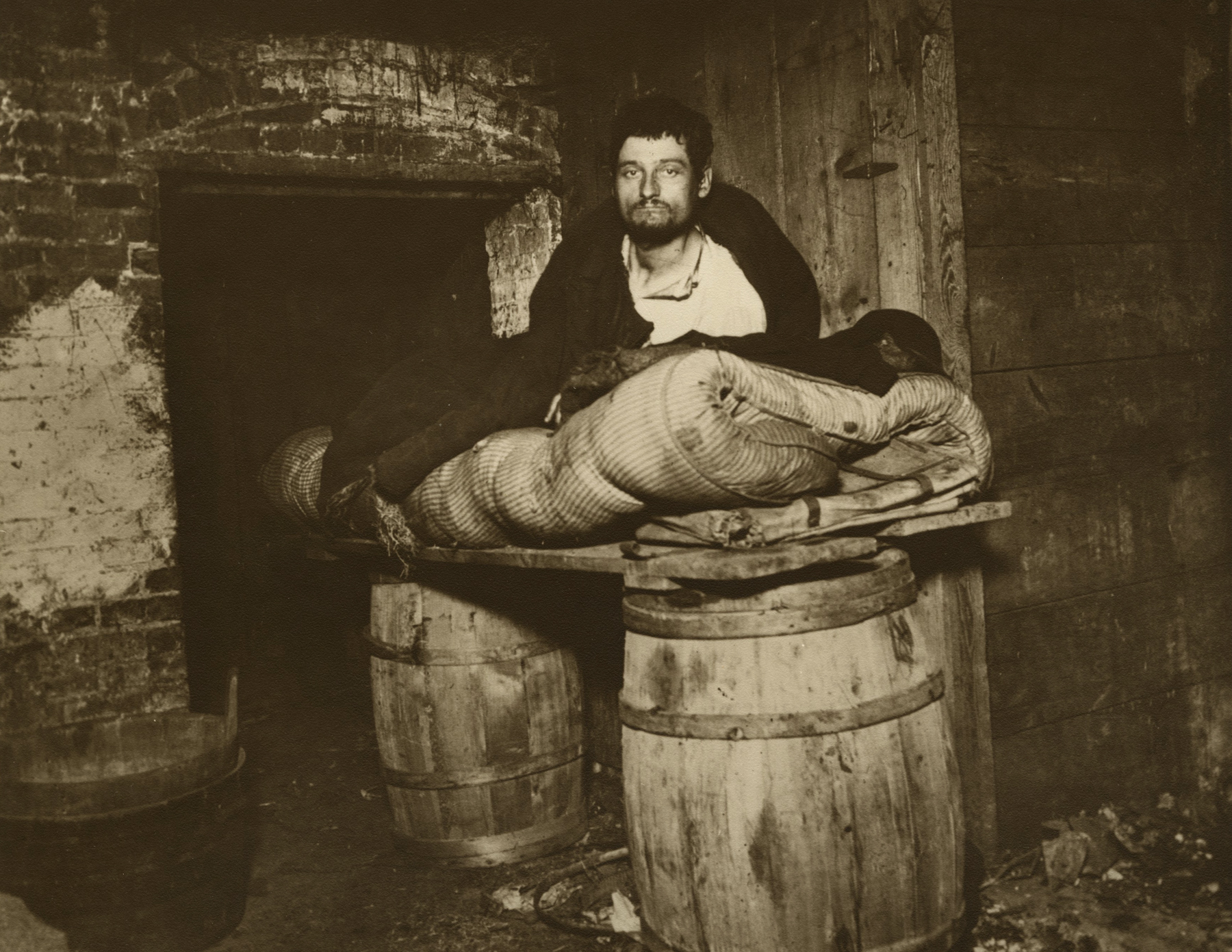 Jacob Riis - One of Four Pedlars Who Slept in the Cellar of 11 Ludlow Street Rear, New York, c.1890 - Howard Greenberg Gallery