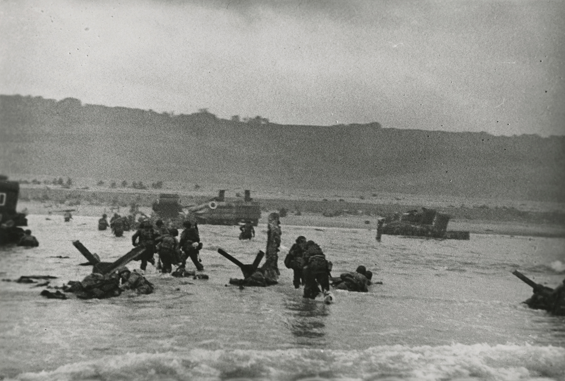 Robert Capa - American soldiers landing on Omaha Beach, D-Day, Normandy, France, 6-Jun-44 - Howard Greenberg Gallery
