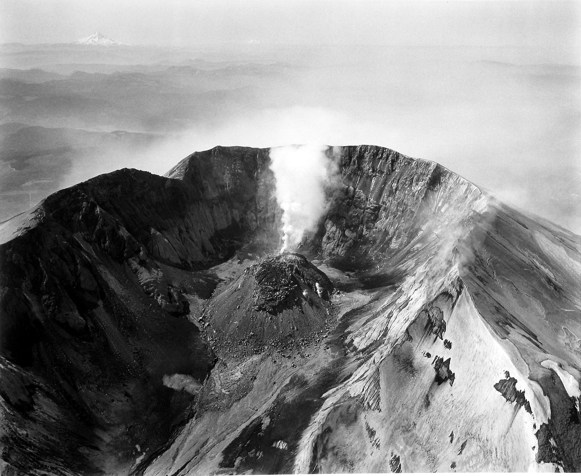 Frank Gohlke - Aerial View of Mt. St. Helens, Crater and Lava Dome, Airplane in the Center, Mt. Hood and Mt. Jefferson in the Distance, 1982 - Howard Greenberg Gallery