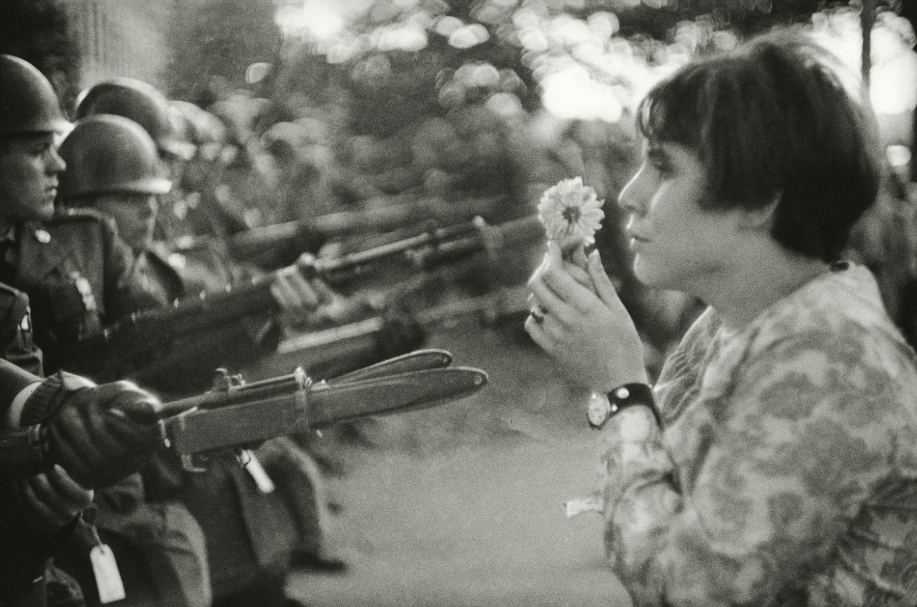 Marc Riboud - Confrontation between a flower and the bayonets of soldiers guarding the Pentagon during the March for Peace in Vietnam, Washington, D.C., 1967 - Howard Greenberg Gallery