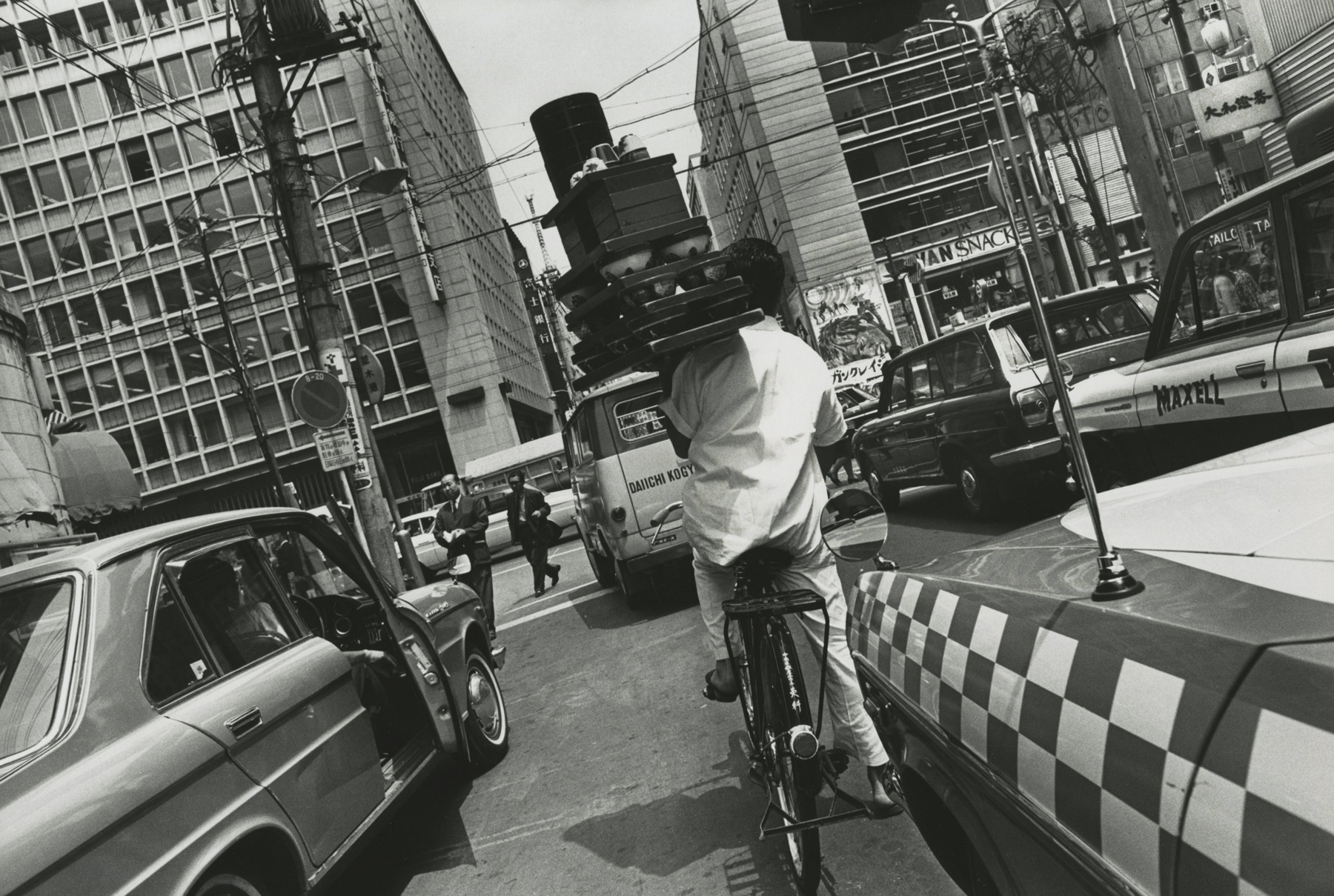Eliot Elisofon - Untitled (delivery man riding bicycle on Japanese street), 1967 - Howard Greenberg Gallery
