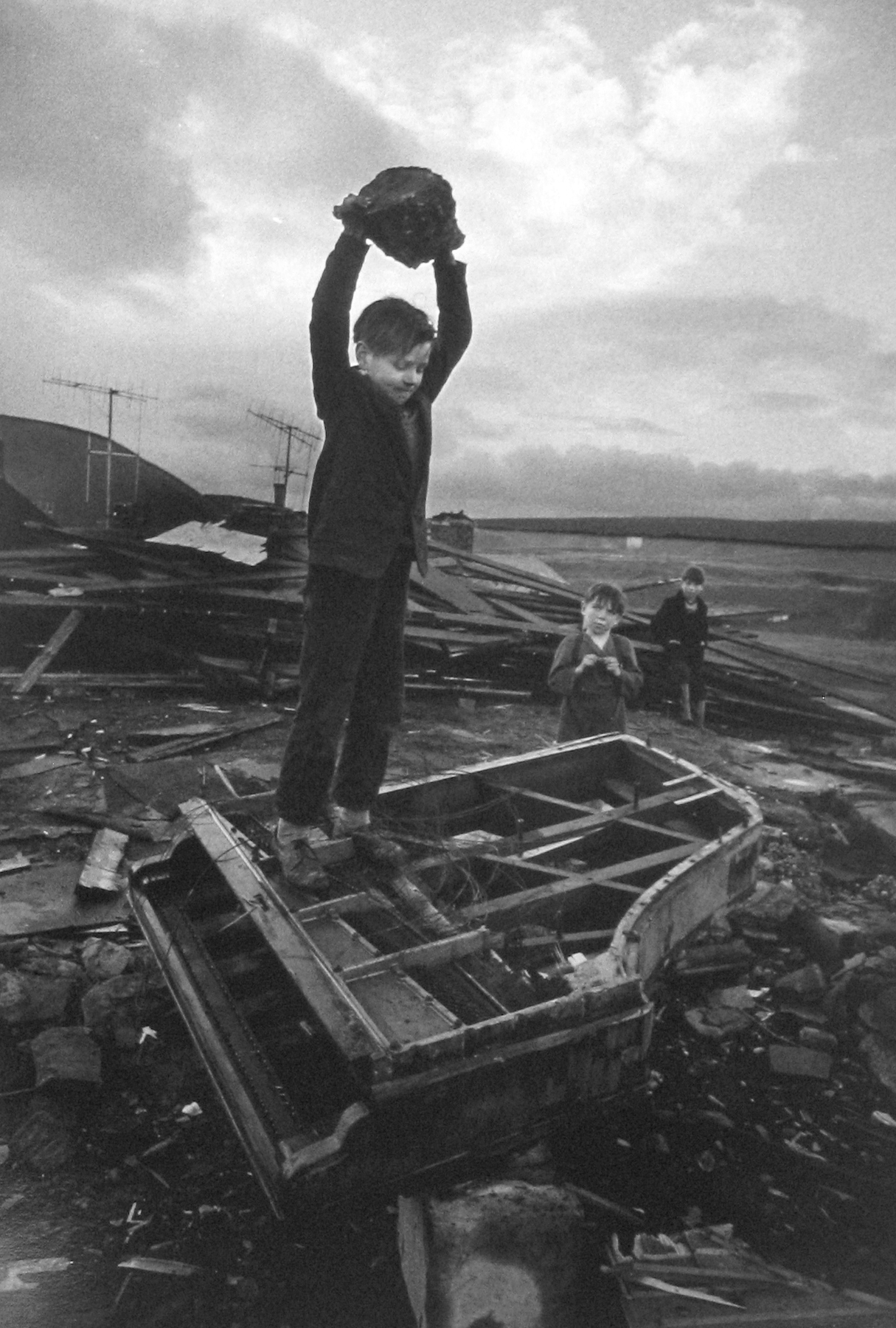 Philip Jones Griffiths - Boy Destroying Piano, Wales, 1961 - Howard Greenberg Gallery
