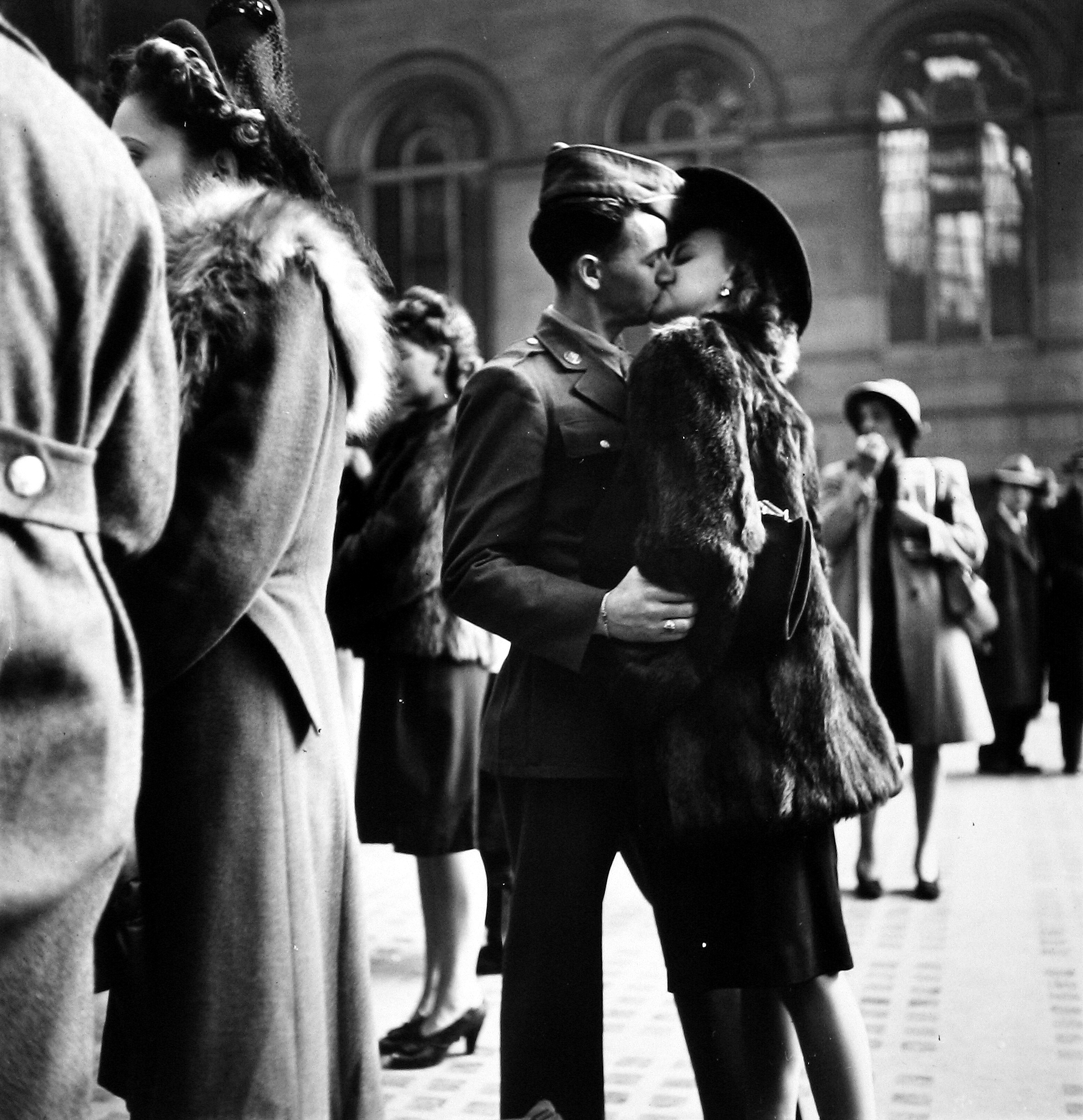 Alfred Eisenstaedt - Couple in Penn Station sharing farewell kiss before he ships off to war during WWII, NY, 1943 - Howard Greenberg Gallery