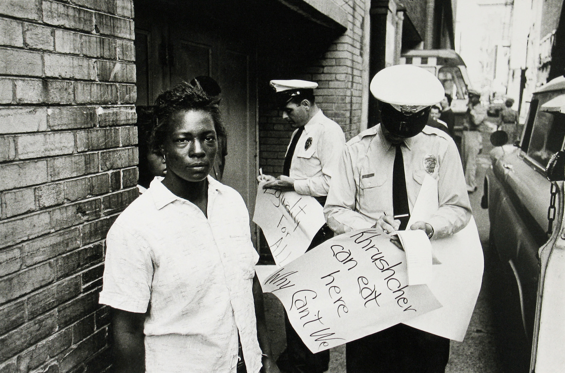 Bob Adelman - Demonstrator arrested behind Loveman's department store - Howard Greenberg Gallery