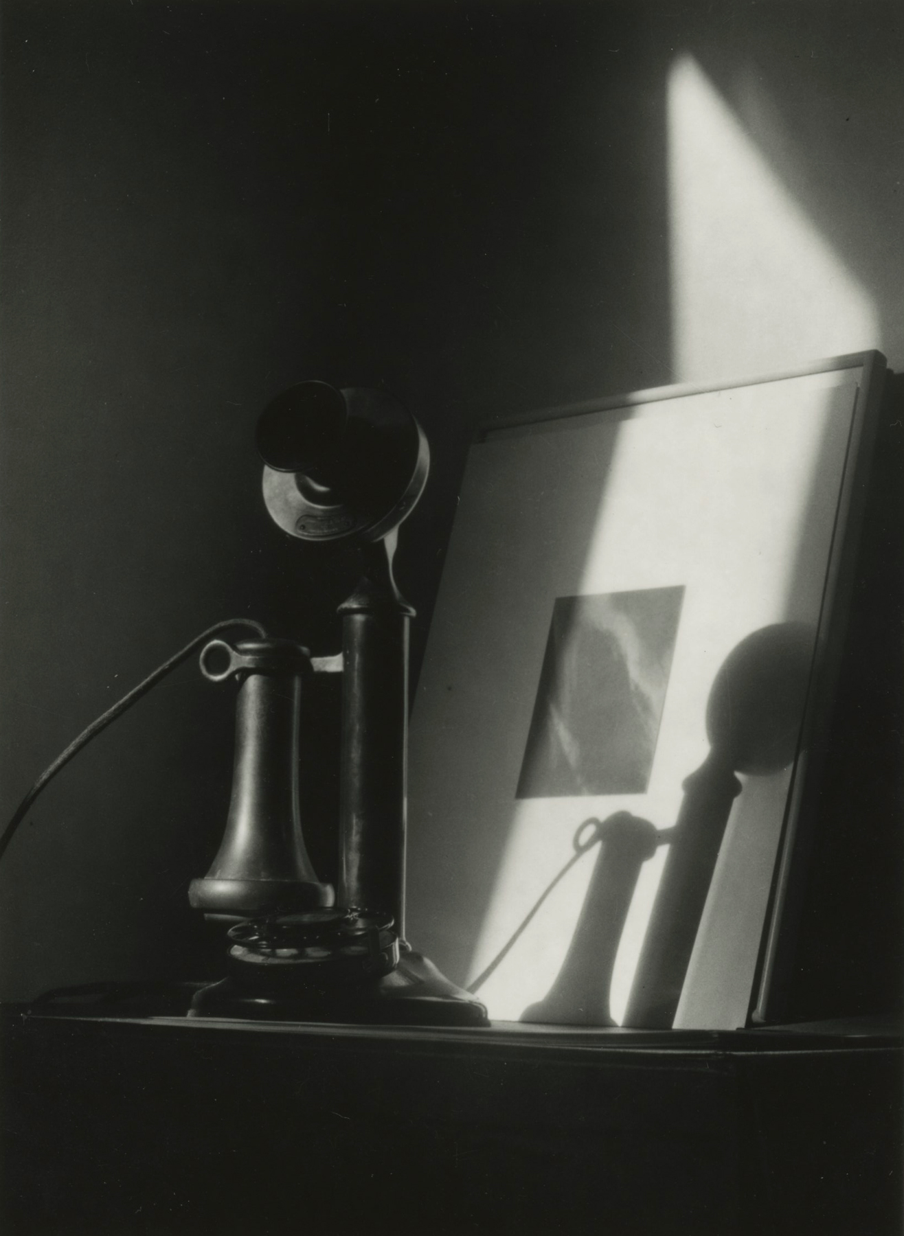 Dorothy Norman - Telephone, in front of Alfred Stieglitz "Equivalent," at An American Place, New York, c. 1940 - Howard Greenberg Gallery