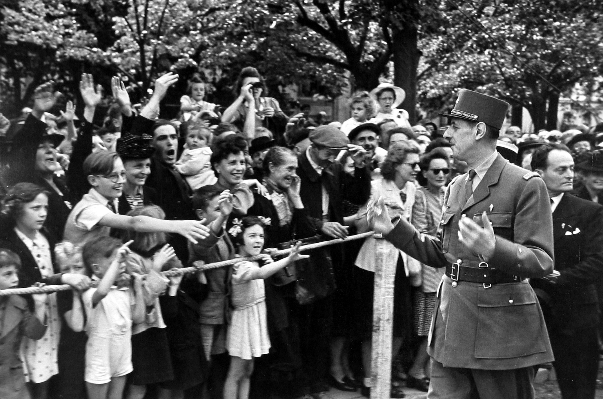 Robert Capa - General Charles de Gaulle leading Parade, 1944 - Howard Greenberg Gallery