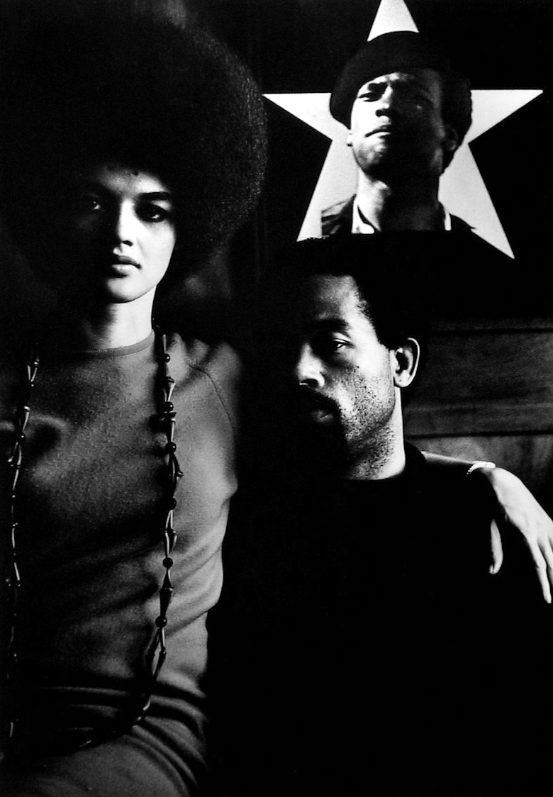 Eldridge Cleaver and his wife, Kathleen with Portrait of Huey Newton, Algiers, Algeria, 1970  Gelatin silver print; printed later  14 x 11 inches