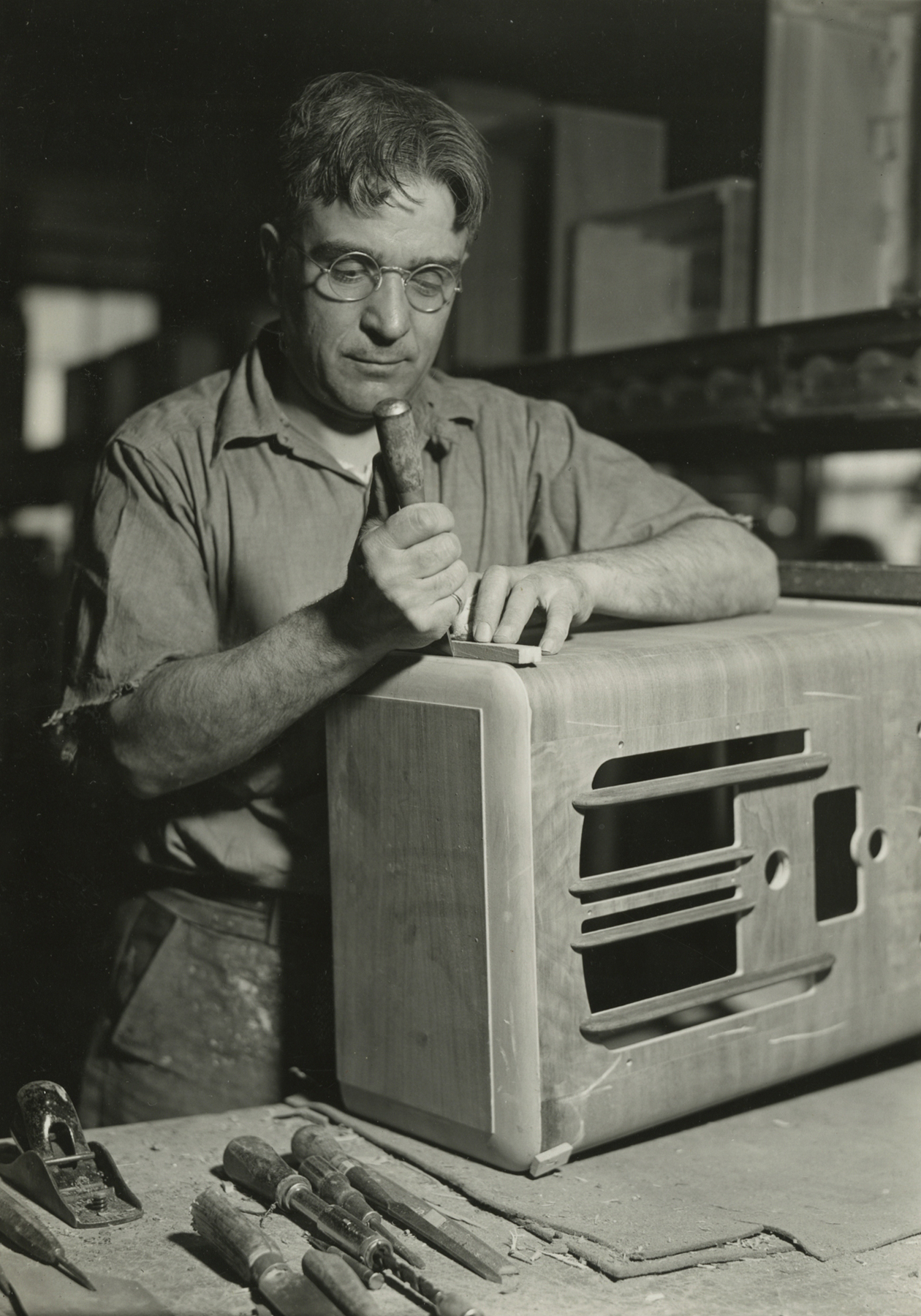 Lewis Hine, Cabinet repair man preparing to cut a piece of veneer. RCA Victor, Camden, New Jersey, March 4, 1937
