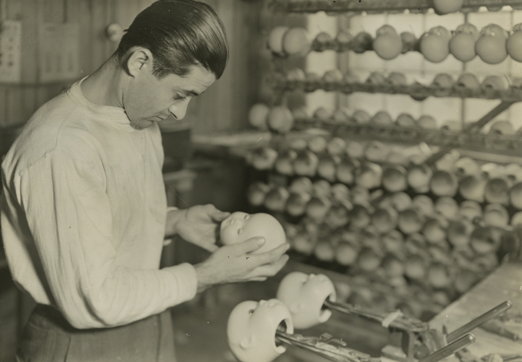 Lewis Hine, Setting eyes in sleeping dolls, Paragon Rubber Co. and American Character Doll, Holyoke, Massachusetts, 1936   Gelatin silver print; printed c.1936   4 5/8 x 6 5/8 inches